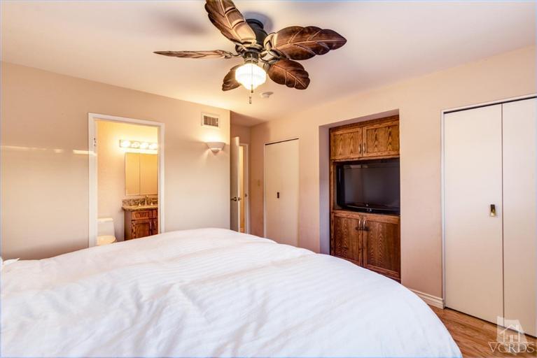 2273 Keystone Street Simi Valley, CA 93063 - Photo 25 of 29 a bedroom with a bed and a chandelier
