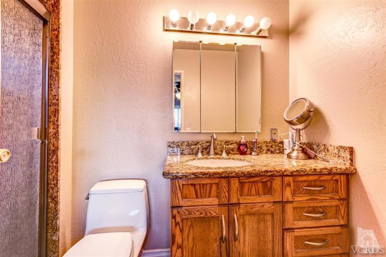 2273 Keystone Street Simi Valley, CA 93063 - Photo 26 of 29 a bathroom with a granite countertop sink vanity mirror and toilet