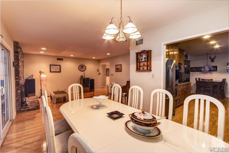 2273 Keystone Street Simi Valley, CA 93063 - Photo 5 of 29 a dining room with wooden floor a chandelier a wooden table and chairs