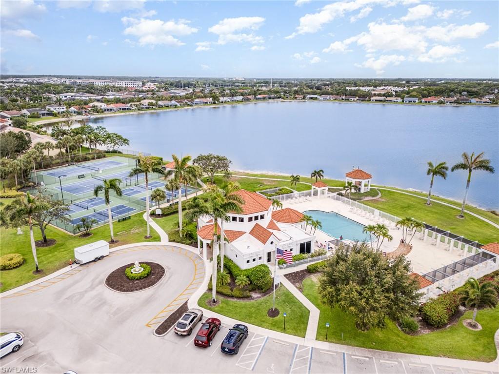 an aerial view of residential houses with outdoor space and ocean view