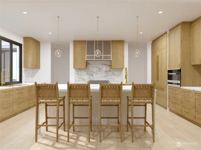 a kitchen with cabinets and chairs