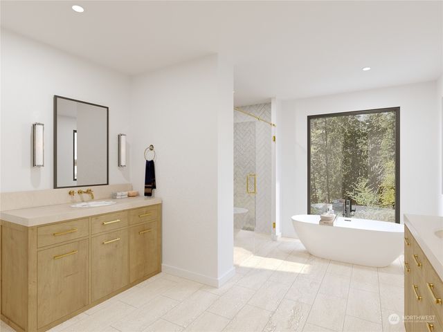 a spacious bathroom with a tub sink and mirror