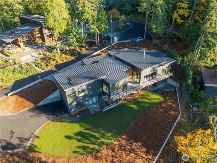 an aerial view of a house with a yard basket ball court and outdoor seating