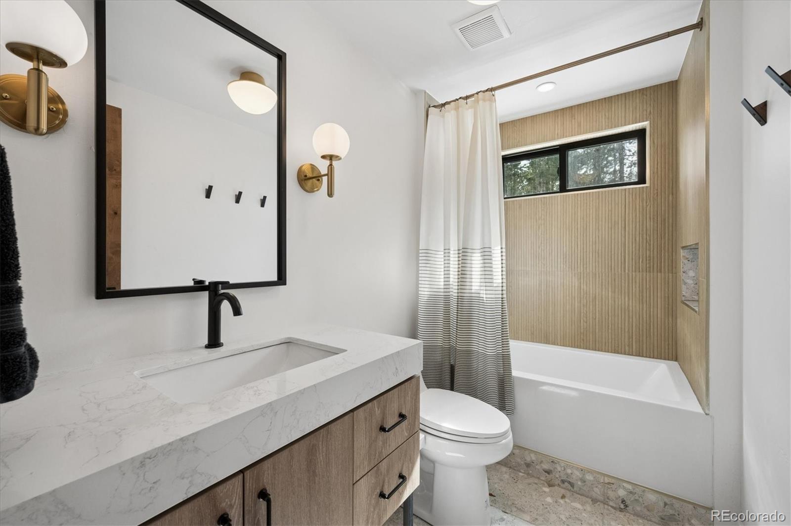 1633 Sinton Road Evergreen, CO 80439 - Photo 36 of 50 a bathroom with a sink a toilet and shower