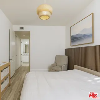 a bedroom with a bed and lamp