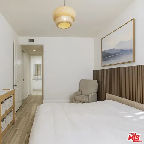 a bedroom with a bed and lamp