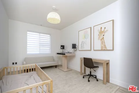 a reading room with wooden floor and a window