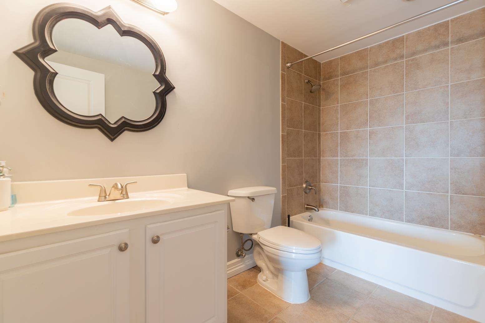 655 Riverside Drive, Unit 406B Memphis, TN 38103 - Photo 14 of 24 a bathroom with a sink and a mirror