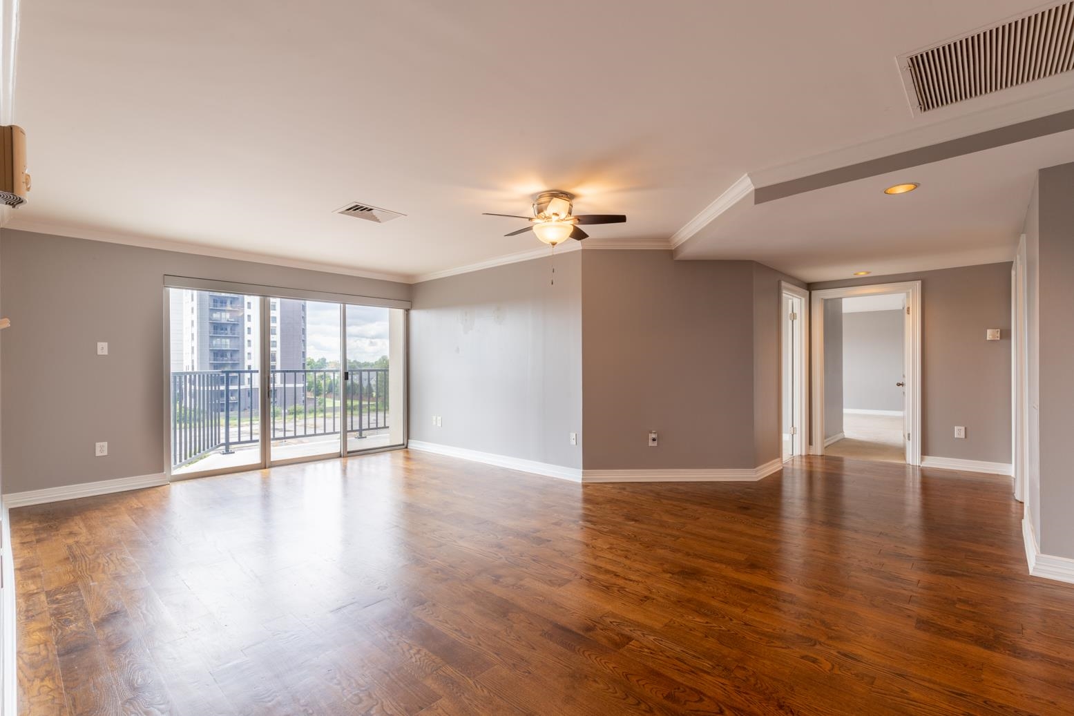 655 Riverside Drive, Unit 406B Memphis, TN 38103 - Photo 7 of 24 a view of an empty room with wooden floor and a window