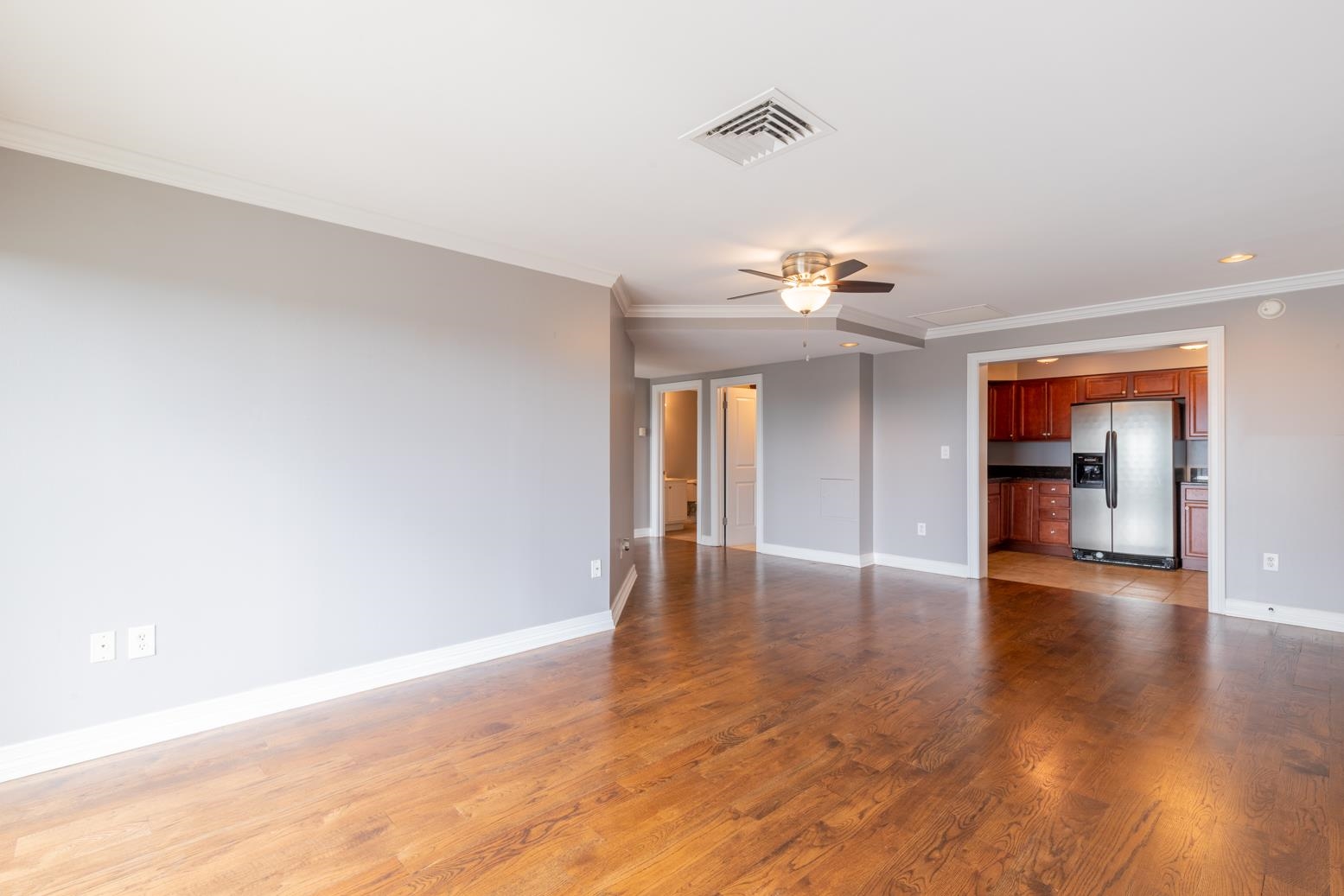 655 Riverside Drive, Unit 406B Memphis, TN 38103 - Photo 8 of 24 a view of an empty room with wooden floor and a window