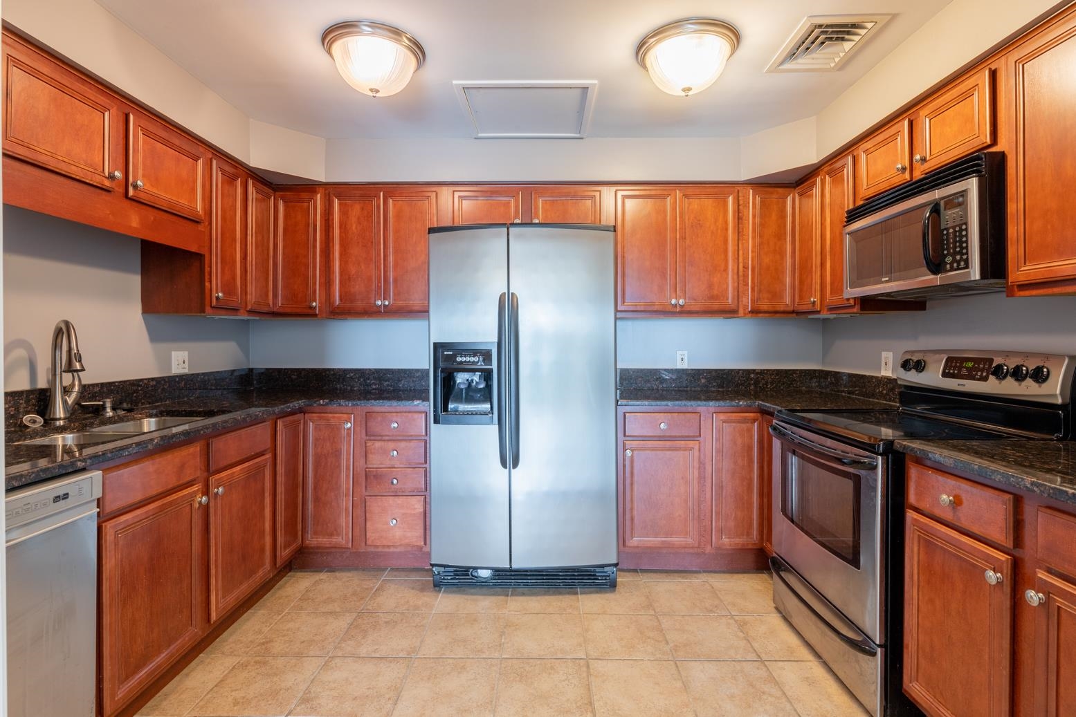 655 Riverside Drive, Unit 406B Memphis, TN 38103 - Photo 9 of 24 a kitchen with stainless steel appliances granite countertop a refrigerator stove a sink and dishwasher