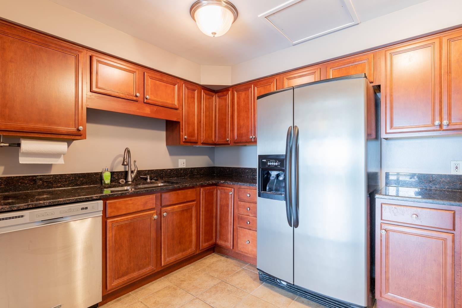 655 Riverside Drive, Unit 406B Memphis, TN 38103 - Photo 10 of 24 a kitchen with stainless steel appliances granite countertop a refrigerator sink and cabinets