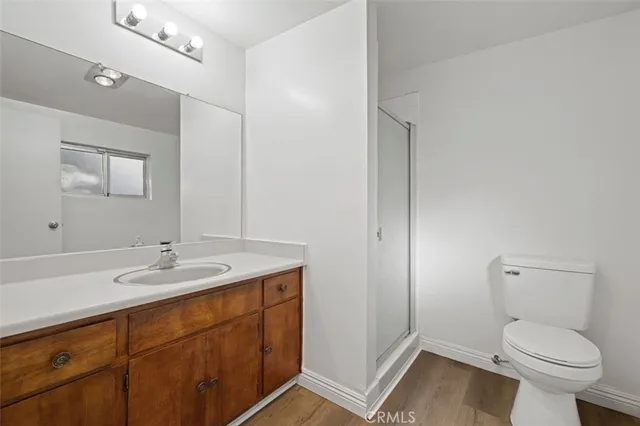 a bathroom with a granite countertop toilet sink and mirror
