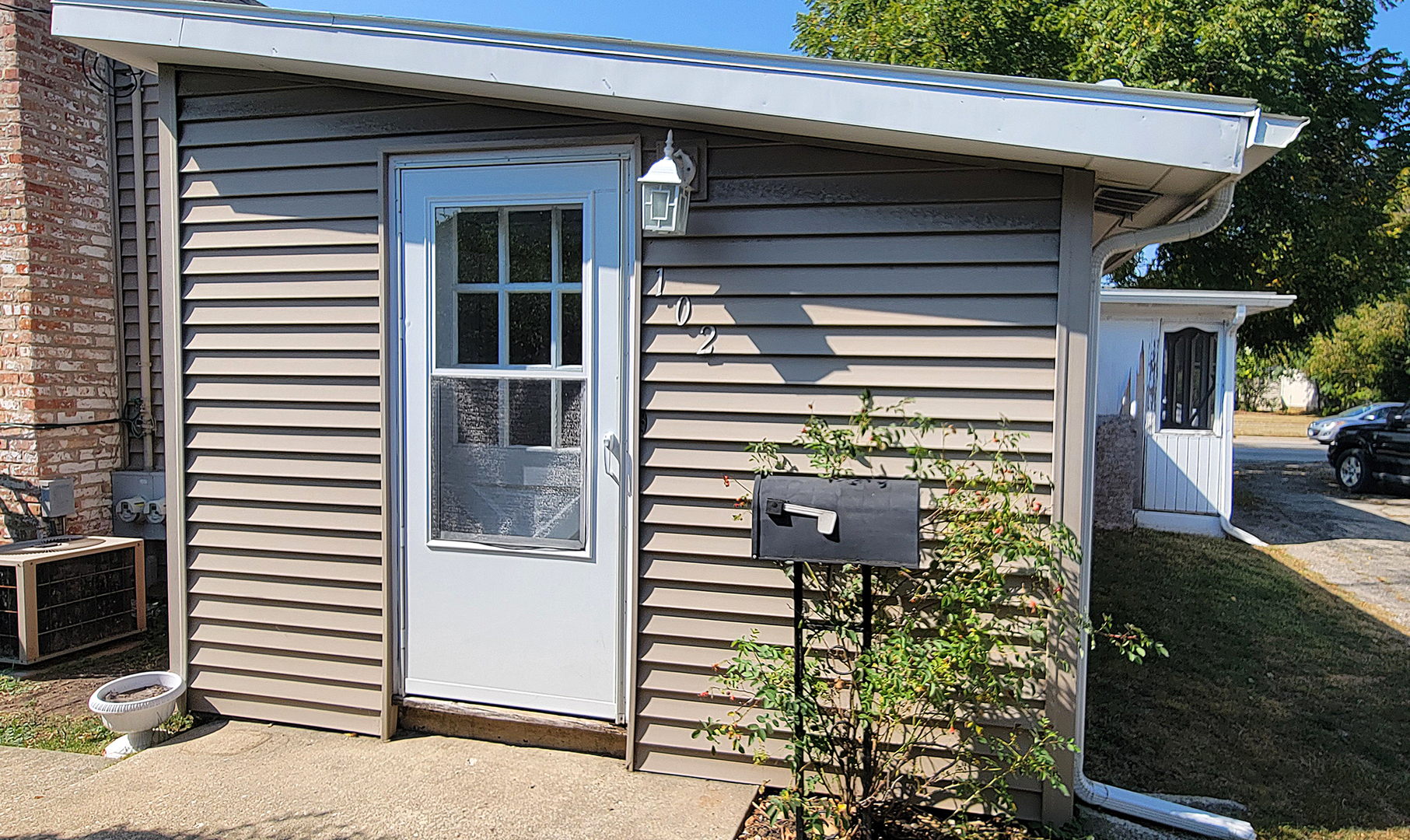 14821 South Bartlett Avenue, Unit 102 Plainfield, IL 60544 - Photo 14 of 14 a view of a house with a door and a window