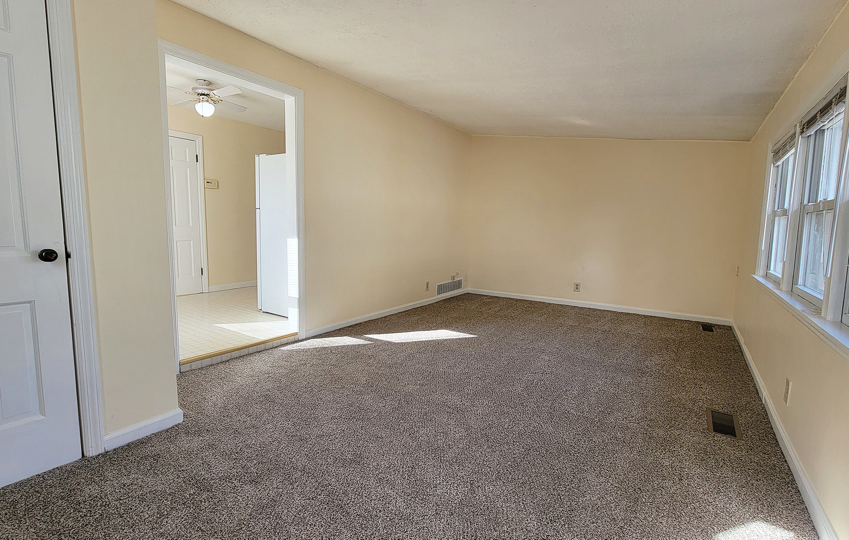 14821 South Bartlett Avenue, Unit 102 Plainfield, IL 60544 - Photo 2 of 14 an empty room with windows