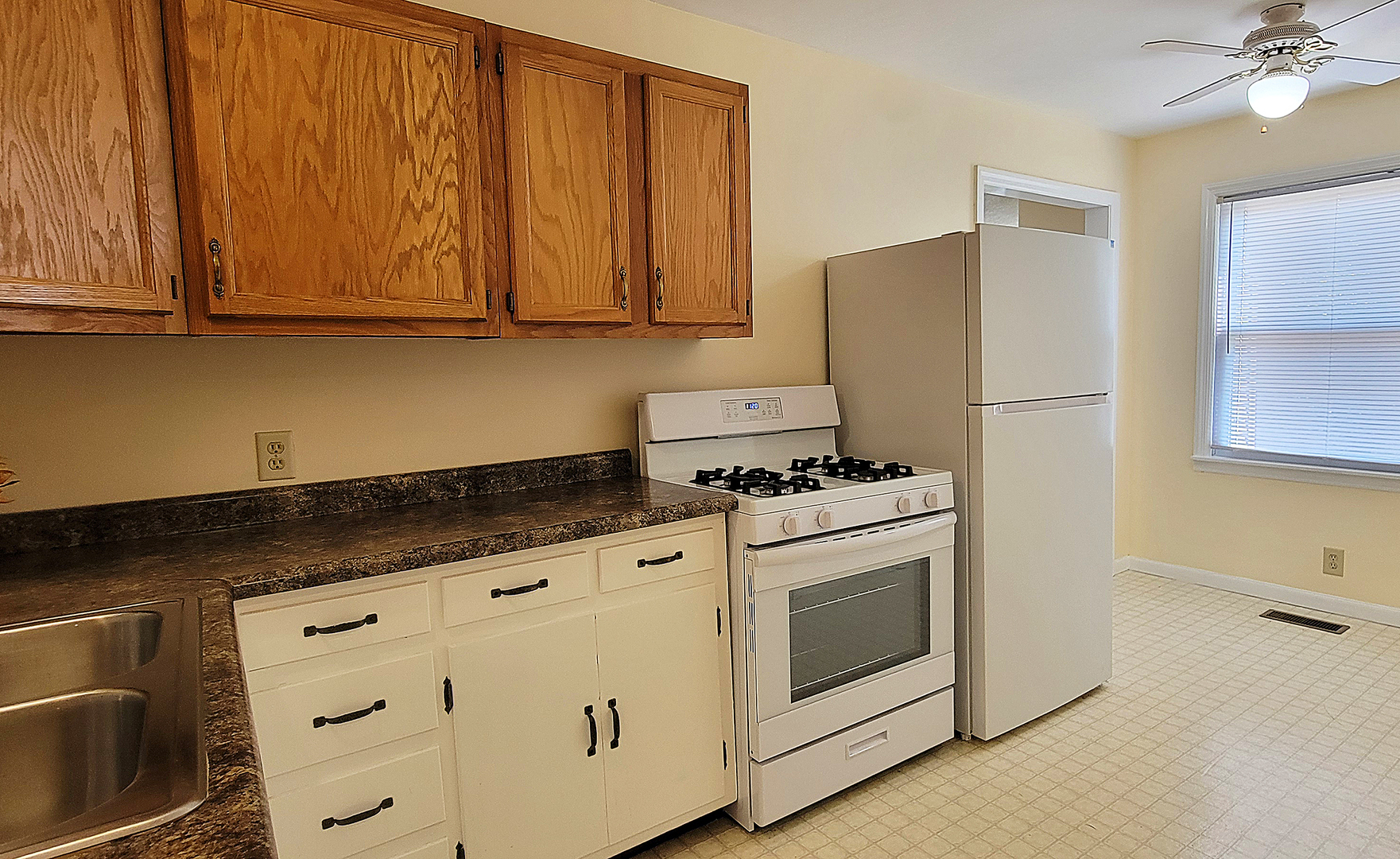 14821 South Bartlett Avenue, Unit 102 Plainfield, IL 60544 - Photo 6 of 14 a kitchen with granite countertop cabinets stainless steel appliances and sink