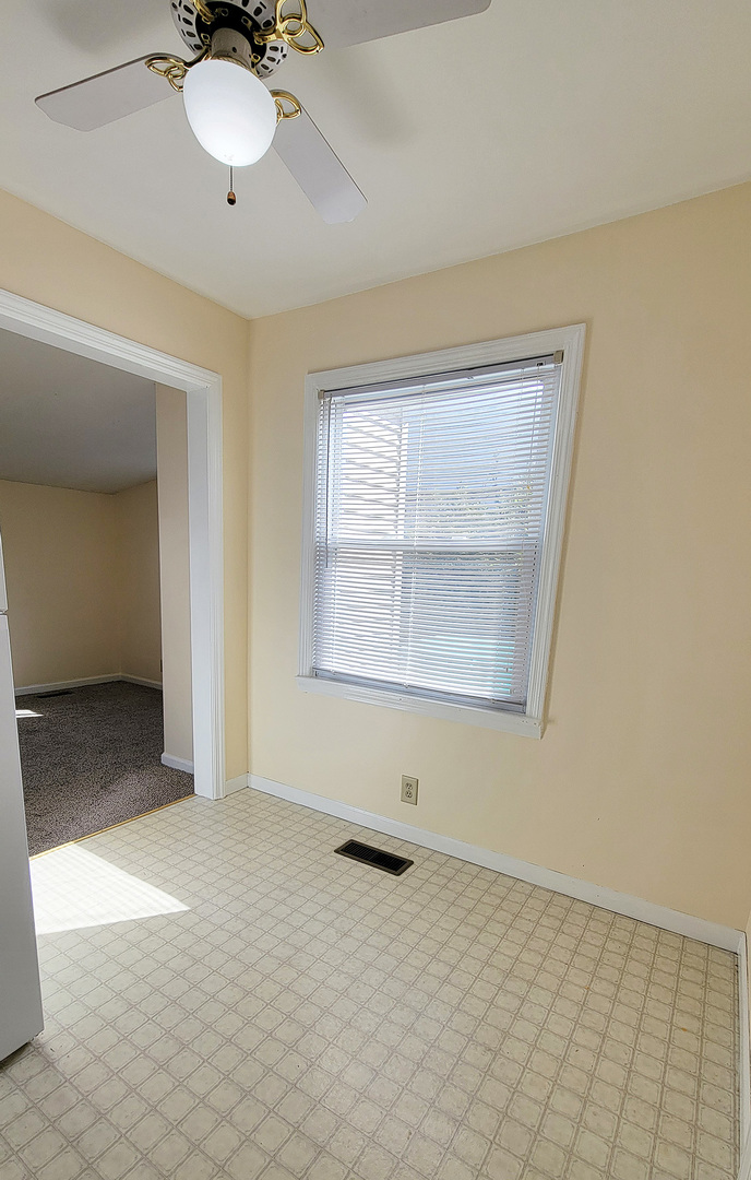 14821 South Bartlett Avenue, Unit 102 Plainfield, IL 60544 - Photo 7 of 14 a view of an empty room with a window