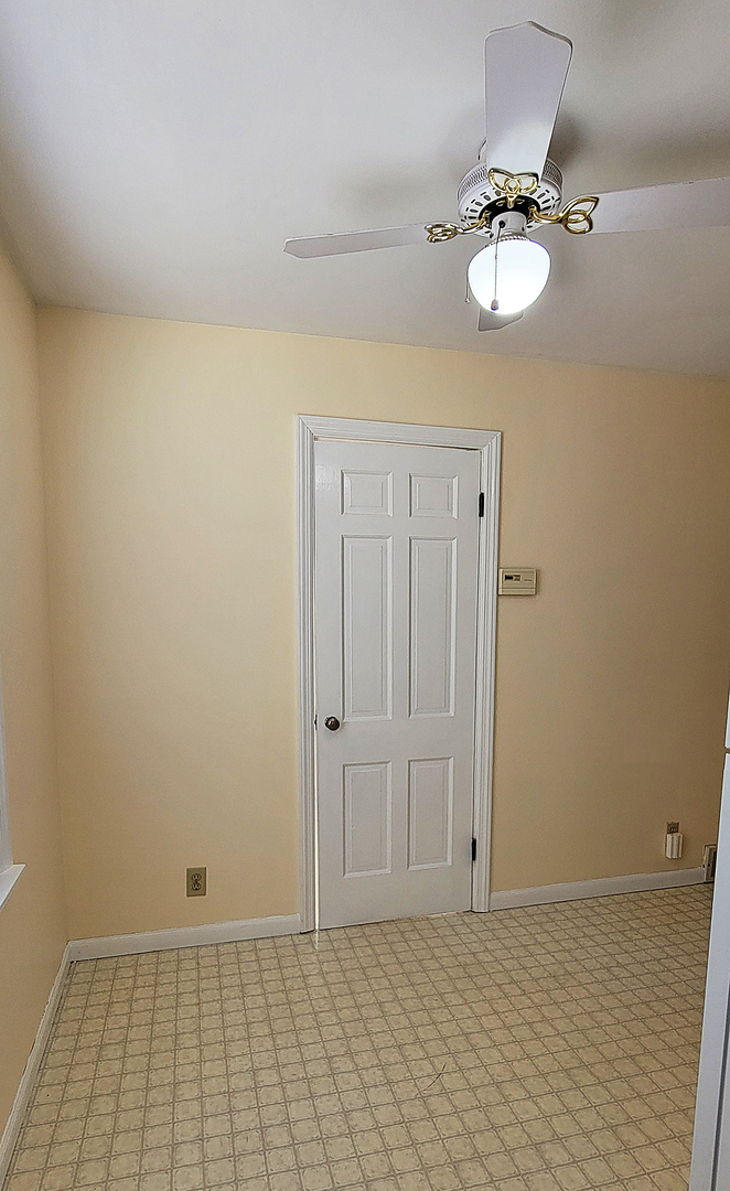 14821 South Bartlett Avenue, Unit 102 Plainfield, IL 60544 - Photo 8 of 14 a view of a room with a chandelier fan and white walls