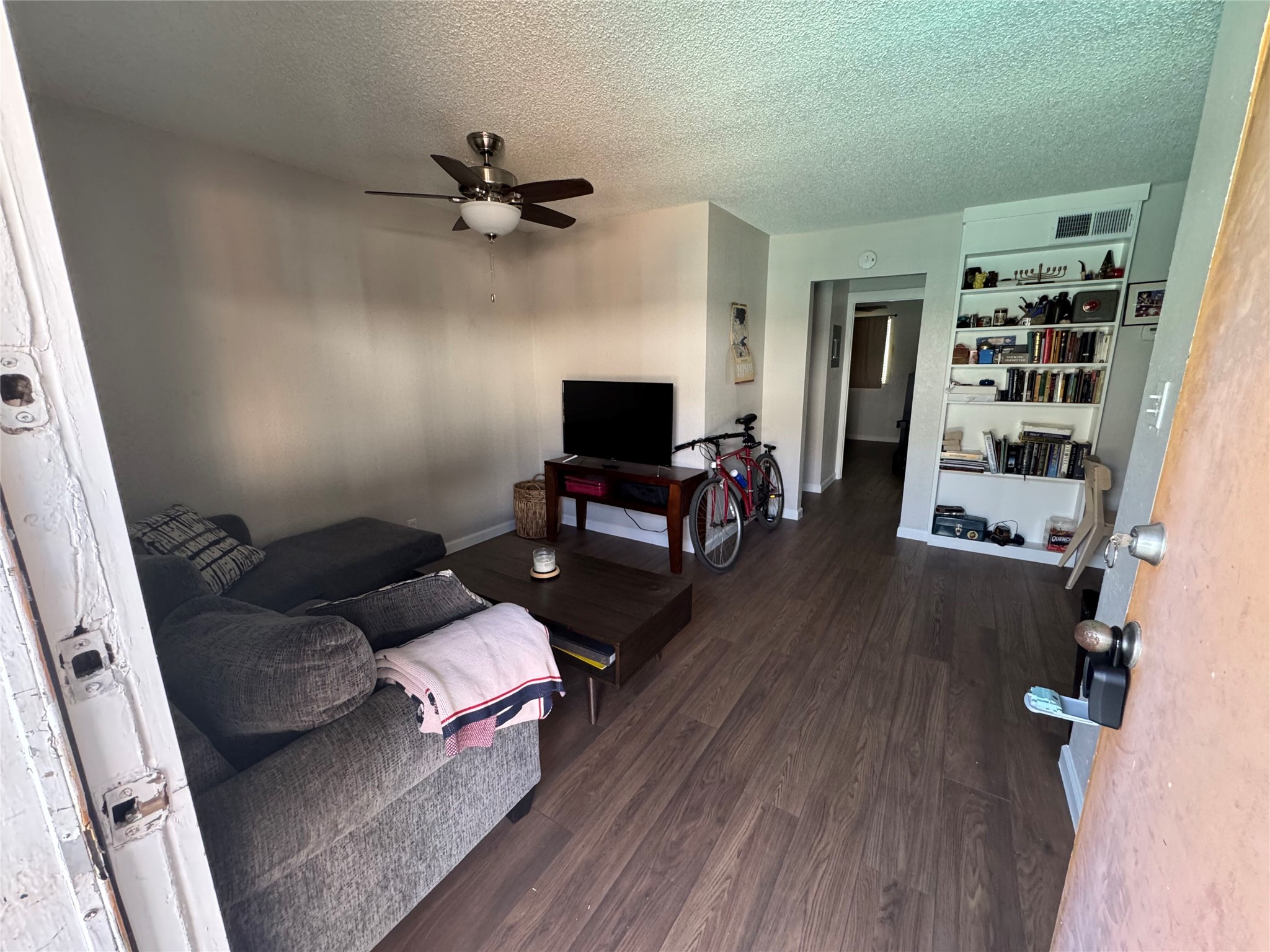 2401 Manor Road, Unit 118 Austin, TX 78722 - Photo 2 of 10 a living room with furniture and a flat screen tv
