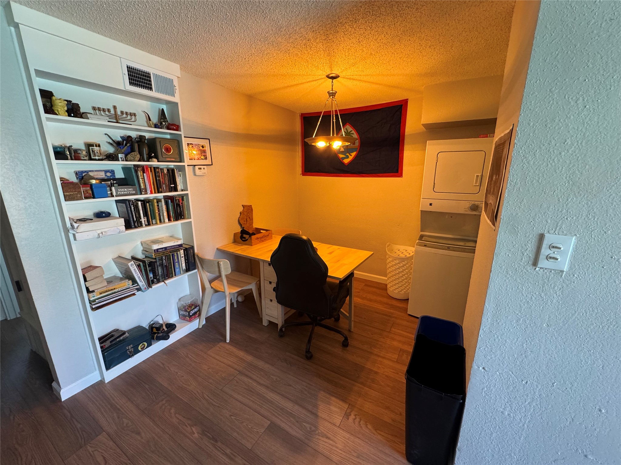 2401 Manor Road, Unit 118 Austin, TX 78722 - Photo 4 of 10 a view of a workspace with furniture and wooden floor