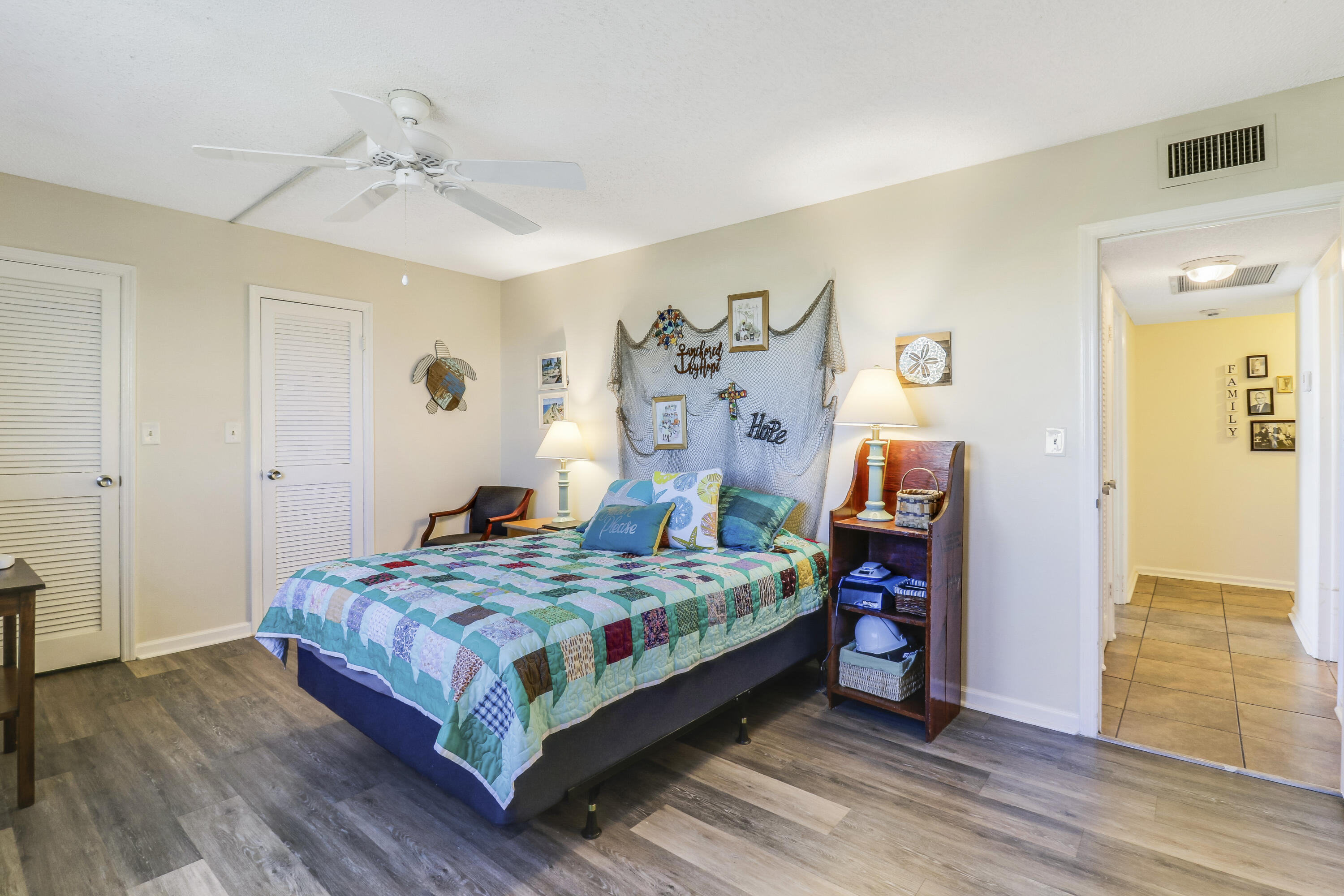 1200 Marine Way, Unit 607 North Palm Beach, FL 33408 - Photo 25 of 53 a bedroom with a bed and wooden floor