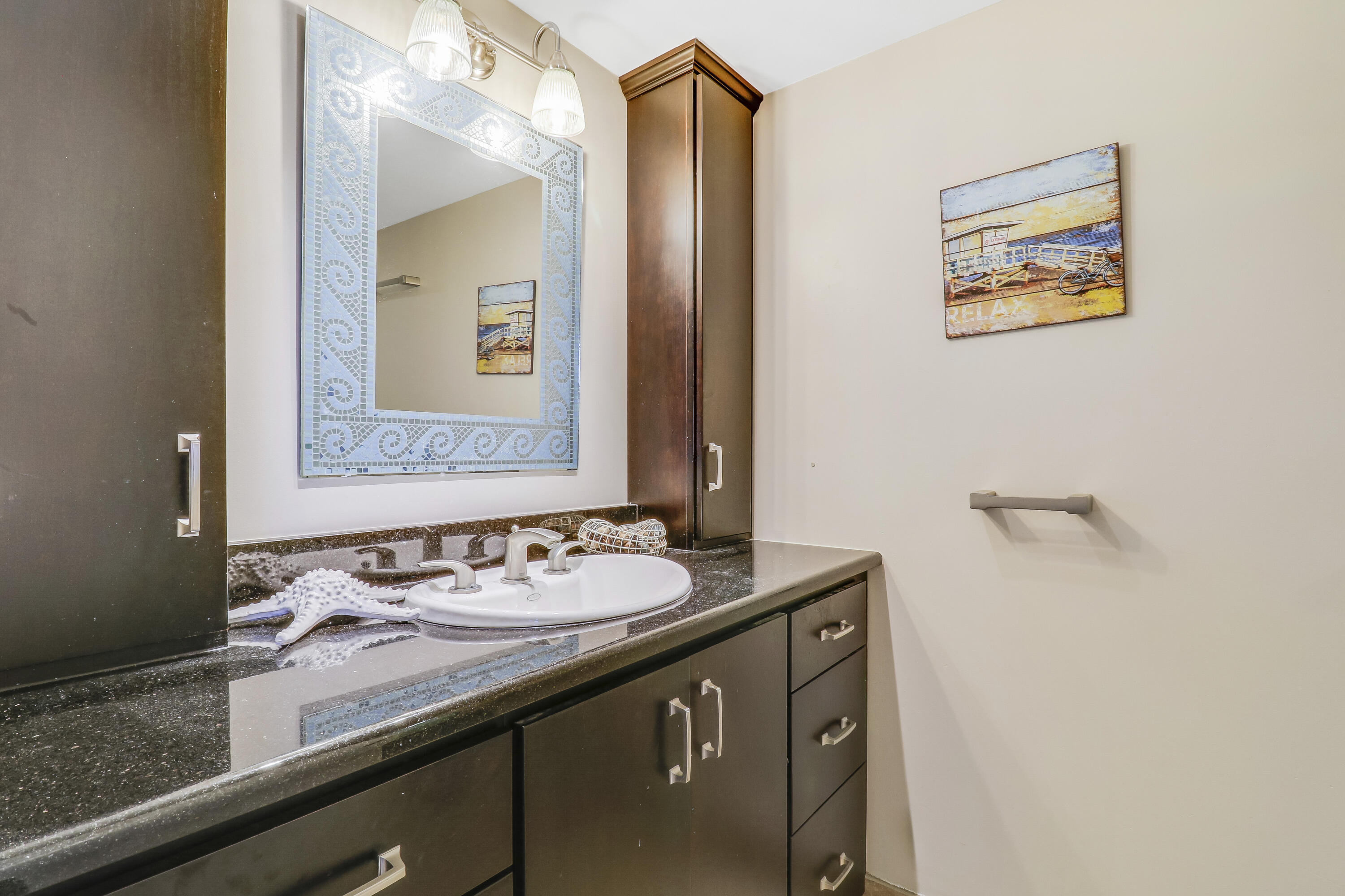 1200 Marine Way, Unit 607 North Palm Beach, FL 33408 - Photo 28 of 53 a bathroom with a granite countertop sink mirror and a