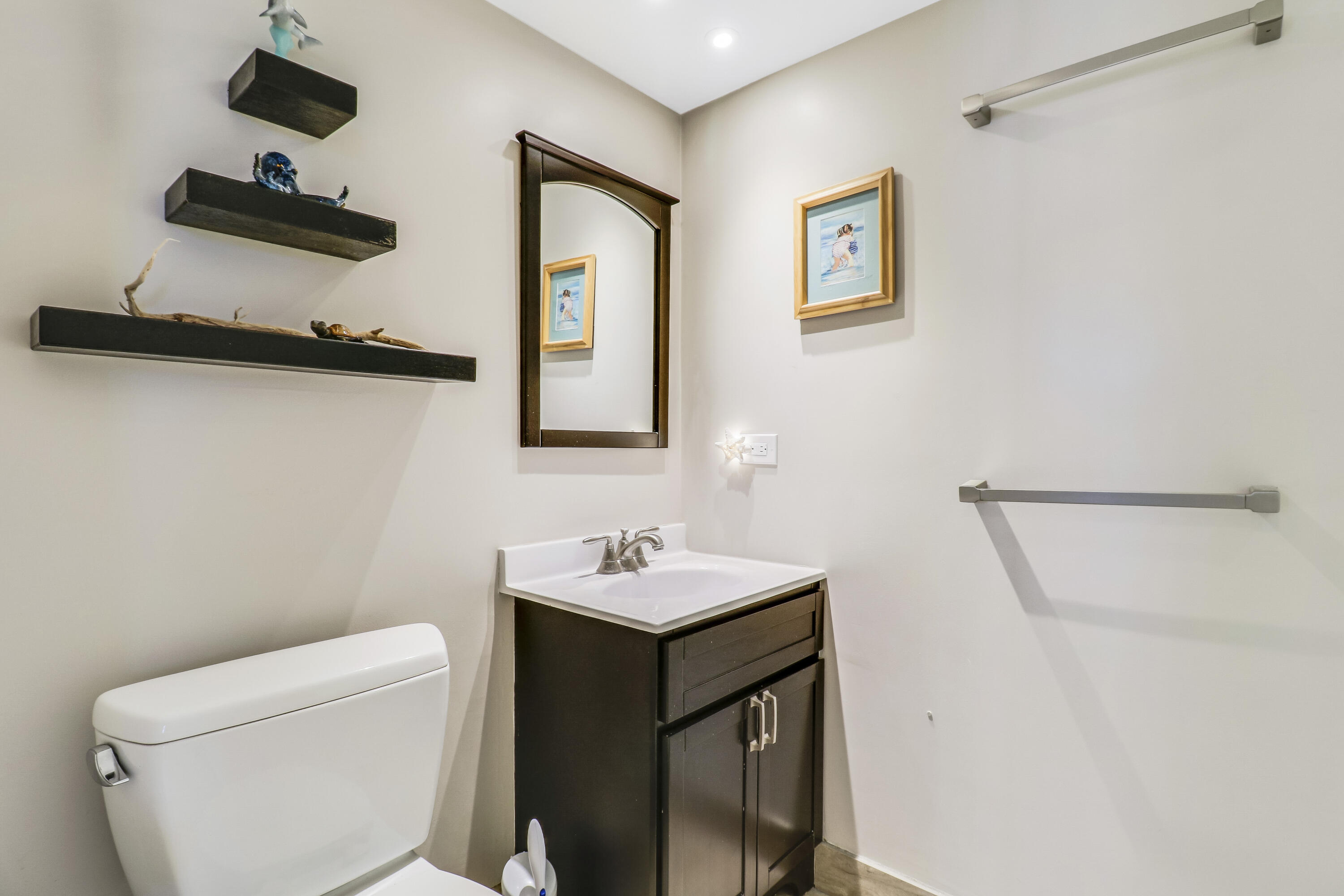 1200 Marine Way, Unit 607 North Palm Beach, FL 33408 - Photo 33 of 53 a bathroom with a toilet sink and mirror