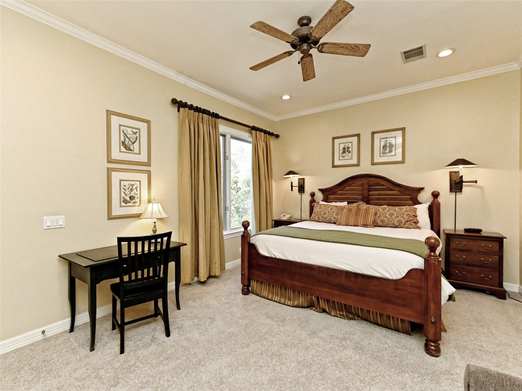 8212 Barton Club Drive, Unit 910 Austin, TX 78735 - Photo 14 of 26 a bedroom with a bed and a chandelier