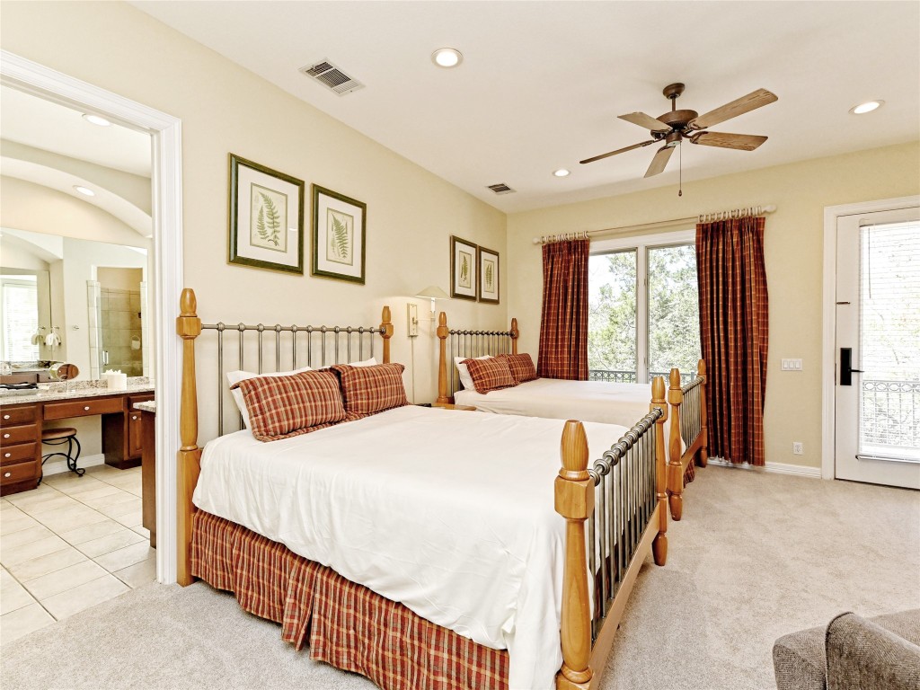 8212 Barton Club Drive, Unit 910 Austin, TX 78735 - Photo 19 of 26 a bed room with a bed and a chandelier