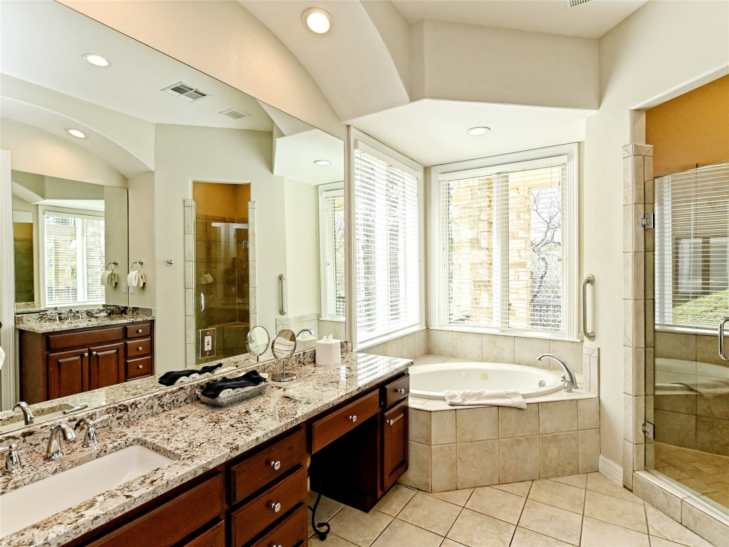 8212 Barton Club Drive, Unit 910 Austin, TX 78735 - Photo 20 of 26 a bathroom with a granite countertop tub sink and mirror