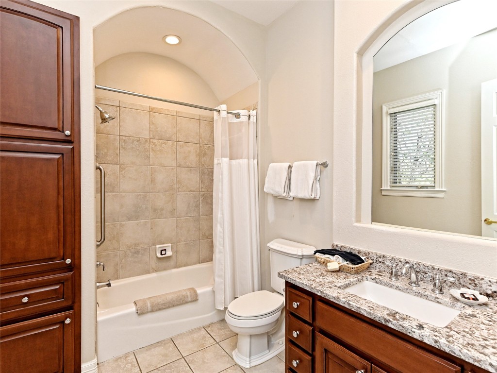 8212 Barton Club Drive, Unit 910 Austin, TX 78735 - Photo 21 of 26 a bathroom with a granite countertop sink a toilet and shower