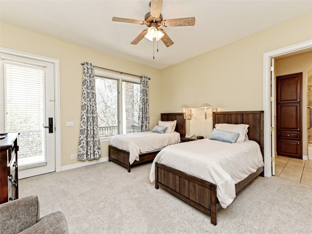 8212 Barton Club Drive, Unit 910 Austin, TX 78735 - Photo 22 of 26 a spacious bedroom with two beds and large windows