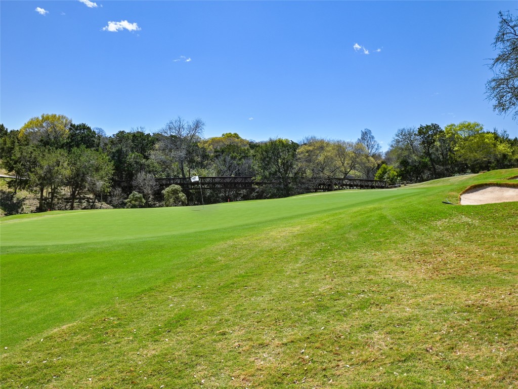 8212 Barton Club Drive, Unit 910 Austin, TX 78735 - Photo 3 of 26 a view of a green field with trees in the background