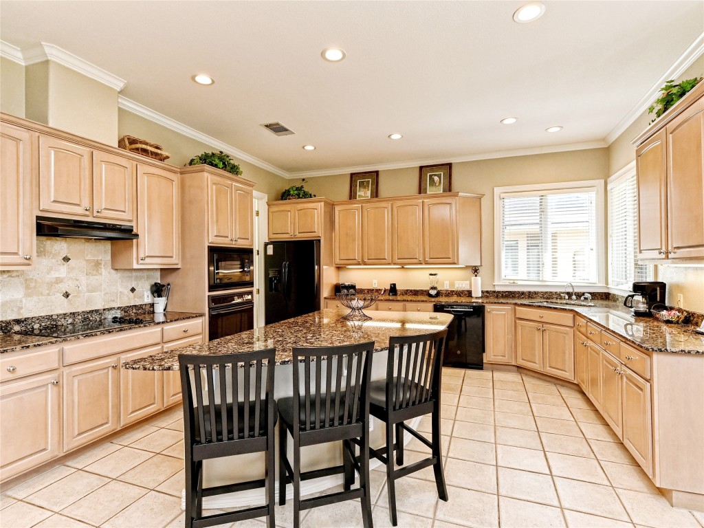 8212 Barton Club Drive, Unit 910 Austin, TX 78735 - Photo 8 of 26 a kitchen with stainless steel appliances granite countertop a stove top oven a sink a dining table and chairs