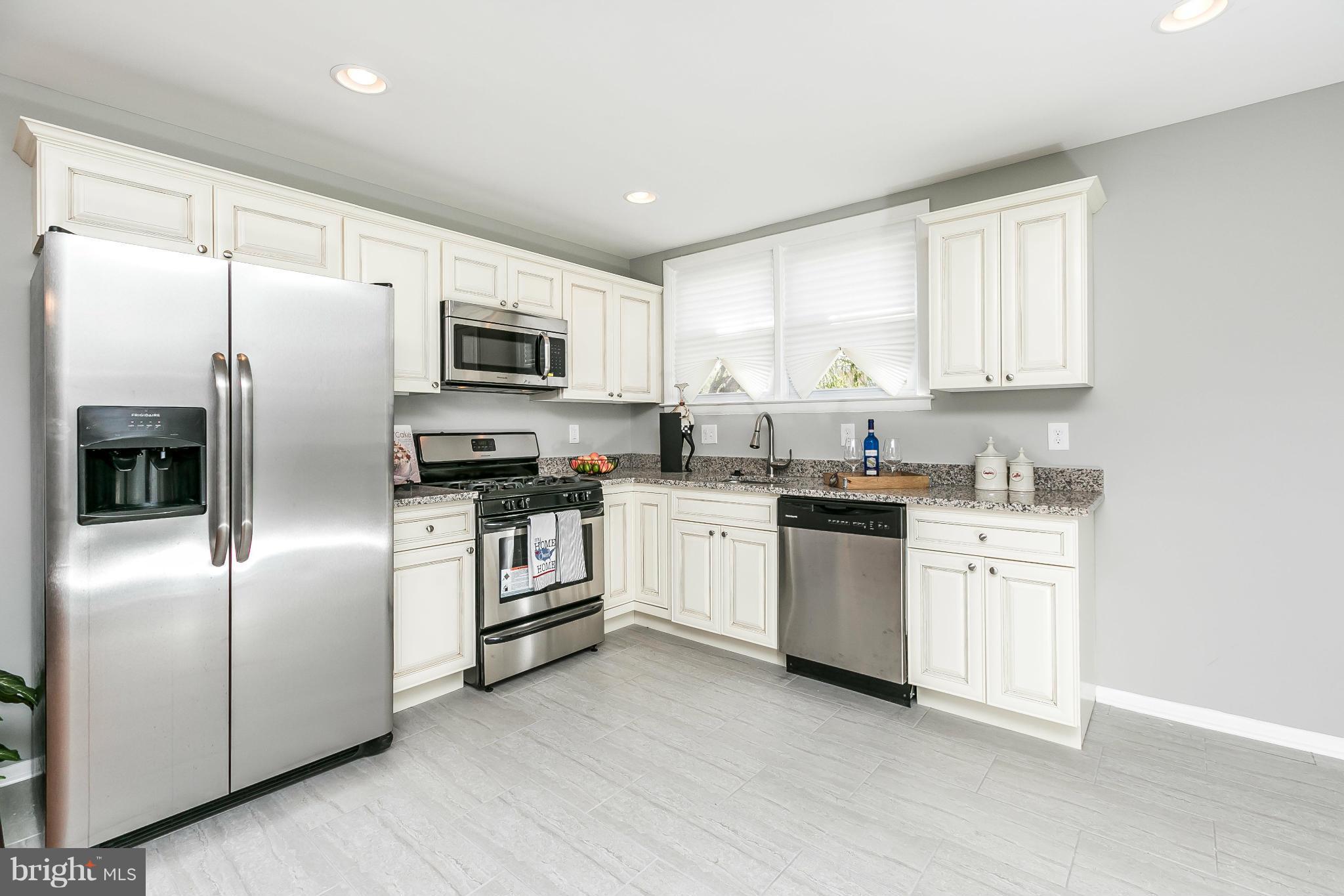 4802 Strathdale Road Baltimore, MD 21206 - Photo 1 of 23 a kitchen with stainless steel appliances granite countertop a refrigerator a stove a sink and a microwave