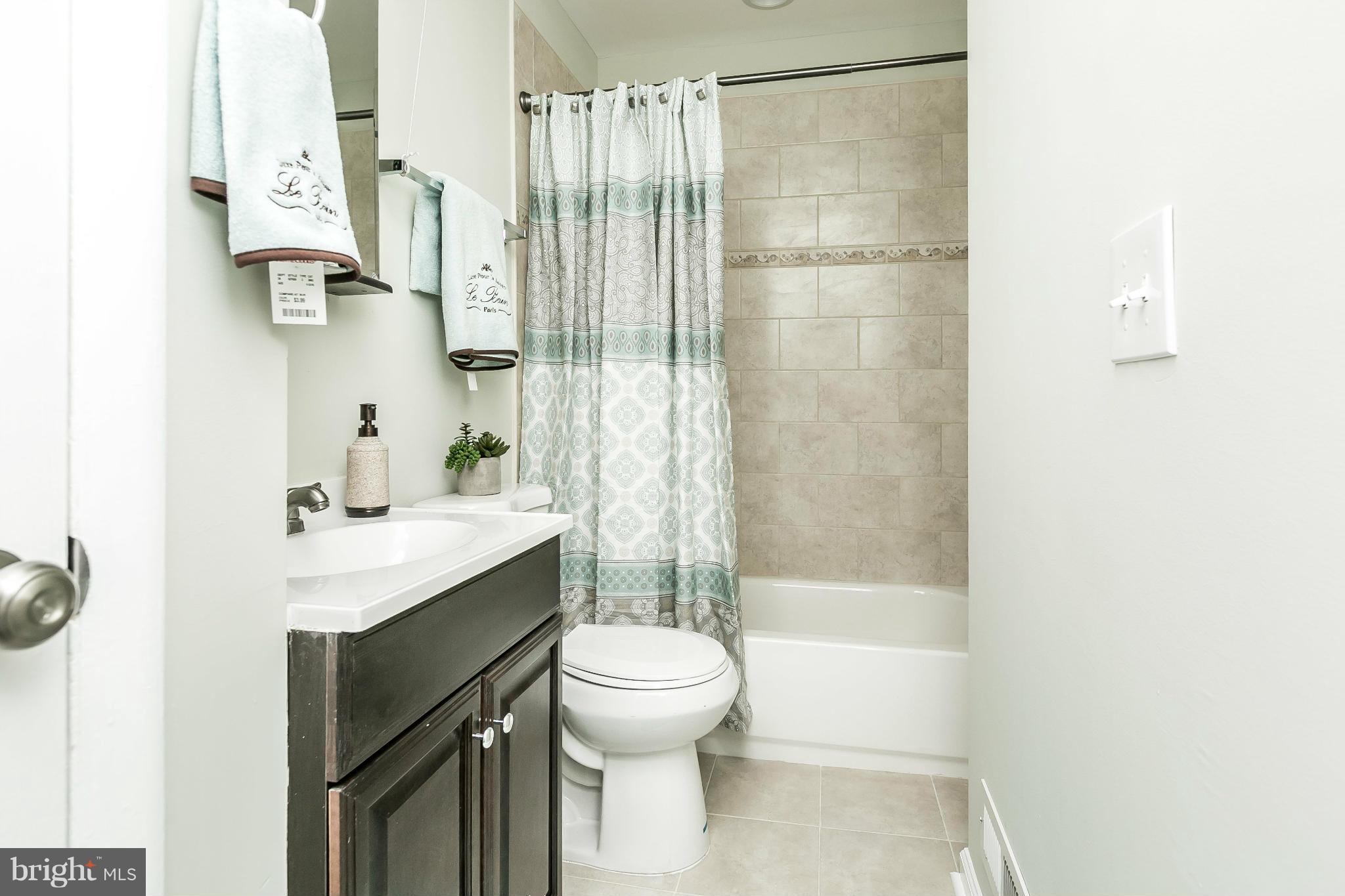 4802 Strathdale Road Baltimore, MD 21206 - Photo 12 of 23 a bathroom with a sink toilet and shower