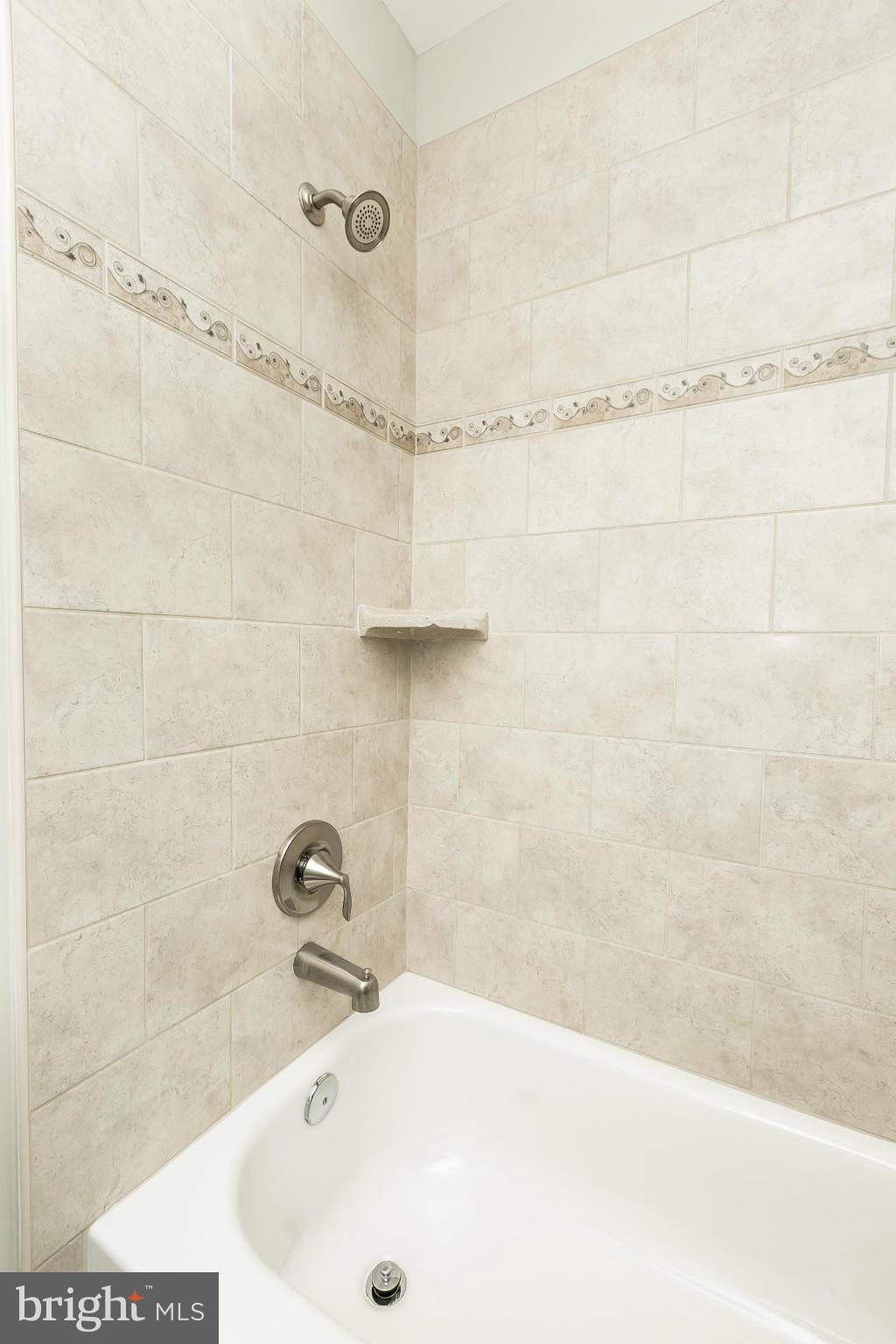 4802 Strathdale Road Baltimore, MD 21206 - Photo 13 of 23 a bathroom with a tub and a shower