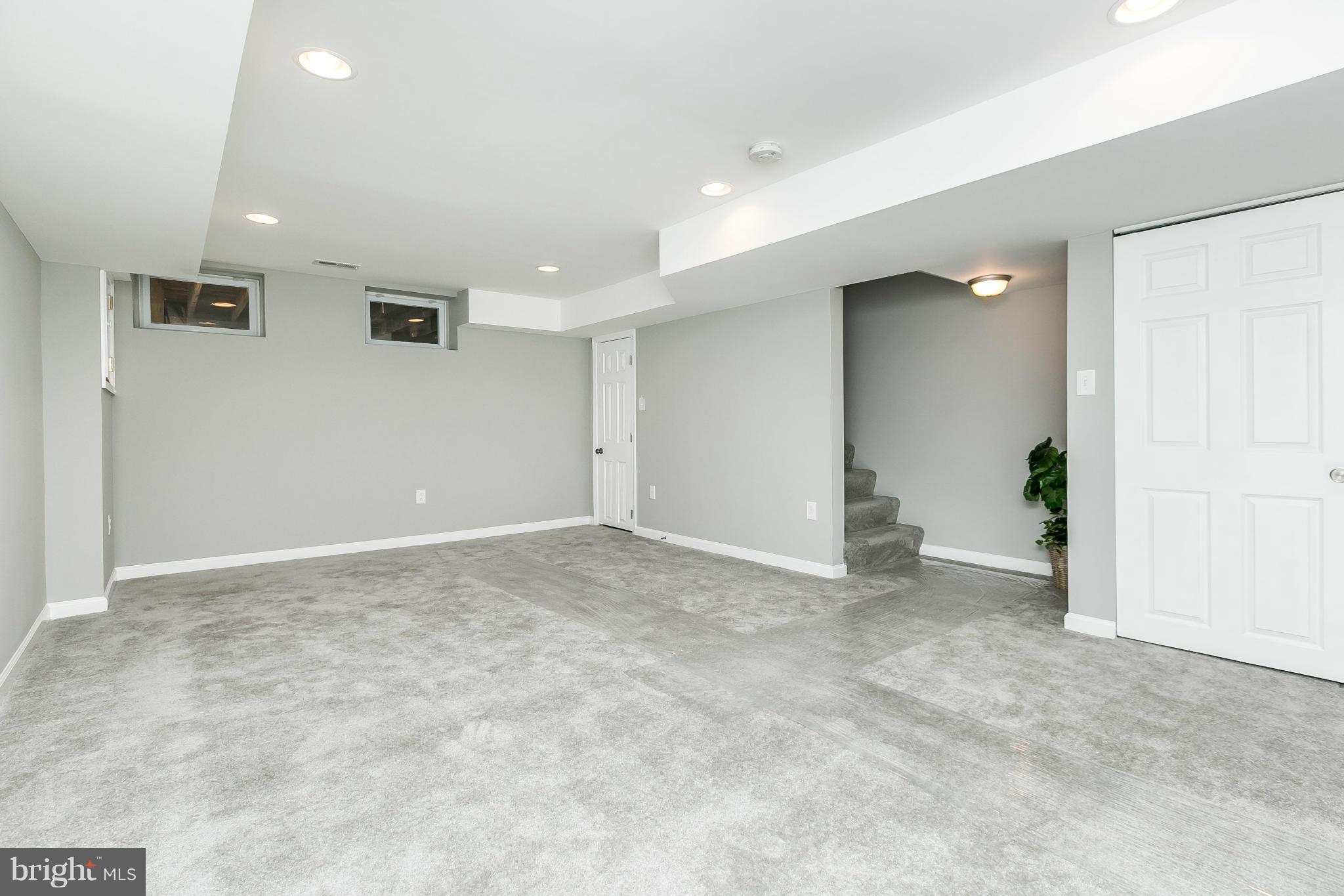 4802 Strathdale Road Baltimore, MD 21206 - Photo 15 of 23 an empty room with windows and entrance to other room