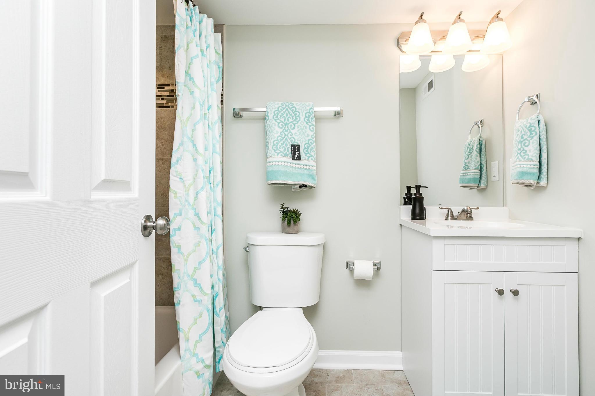 4802 Strathdale Road Baltimore, MD 21206 - Photo 17 of 23 a bathroom with a toilet a sink and a mirror