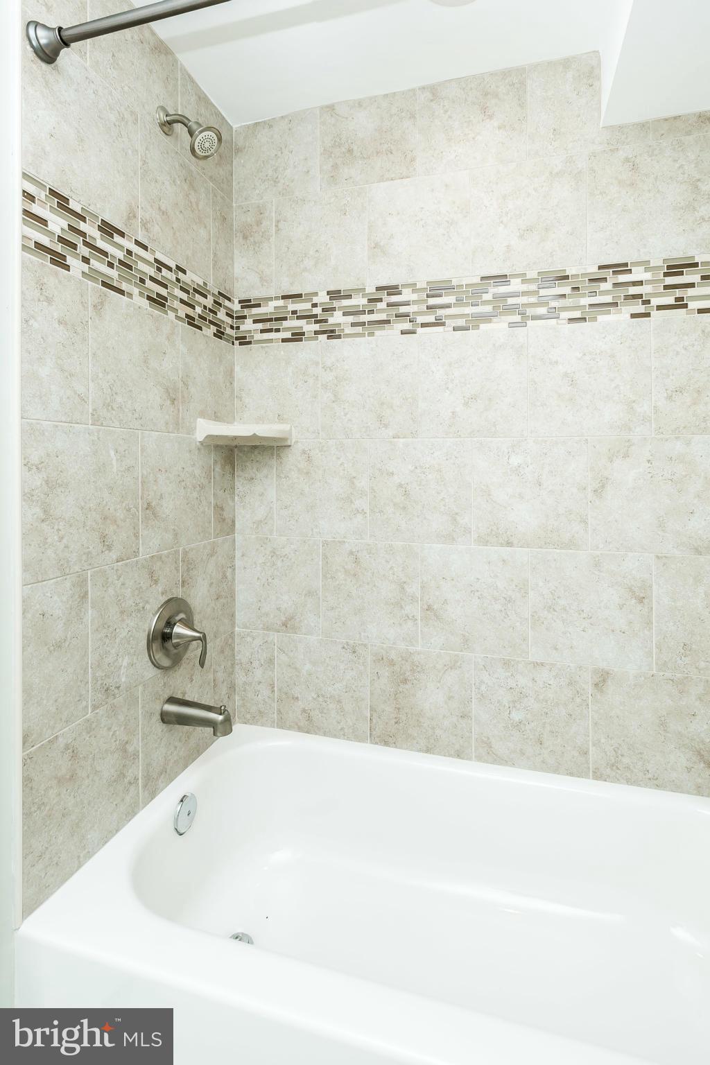 4802 Strathdale Road Baltimore, MD 21206 - Photo 18 of 23 a bathroom with a bathtub and a shower