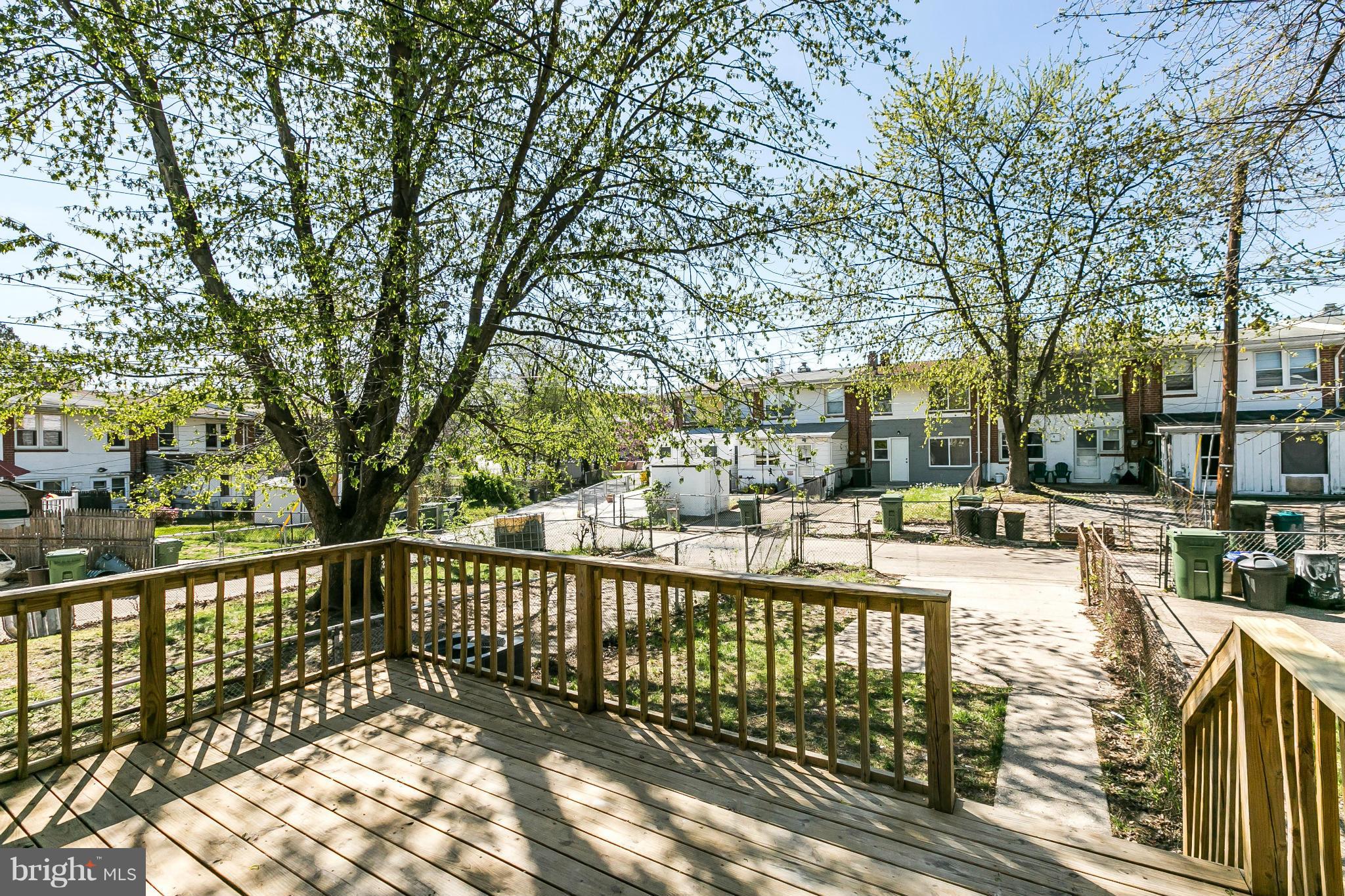 4802 Strathdale Road Baltimore, MD 21206 - Photo 19 of 23 a view of a patio with wooden fence and large trees