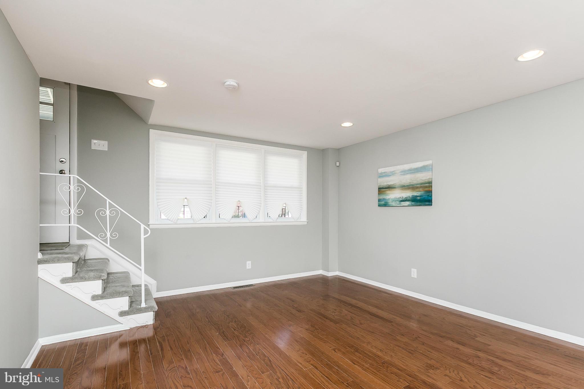 4802 Strathdale Road Baltimore, MD 21206 - Photo 5 of 23 a view of an empty room with wooden floor and a window