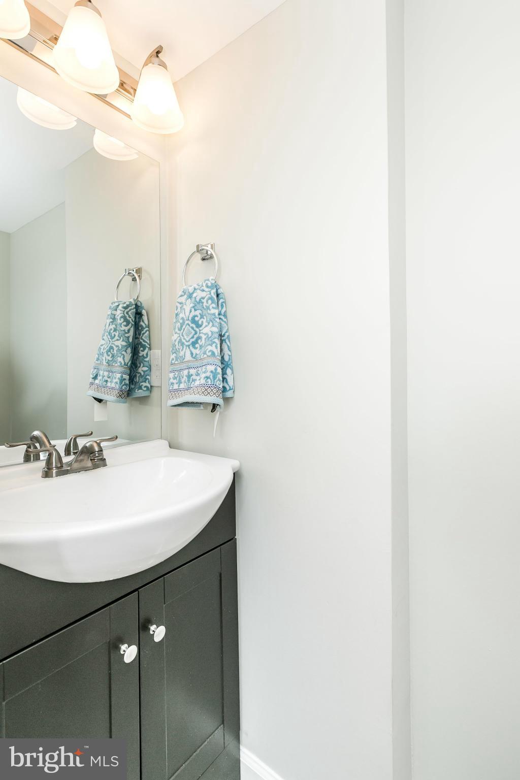 4802 Strathdale Road Baltimore, MD 21206 - Photo 9 of 23 a bathroom with a sink and a mirror