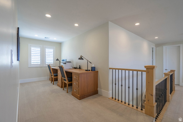 3166 South Tallow Tree Drive St. George, UT 84790 - Photo 25 of 32 Spacious carpeted room featuring plantation shutters, recessed lighting, and a wood-finish railing with black iron balusters