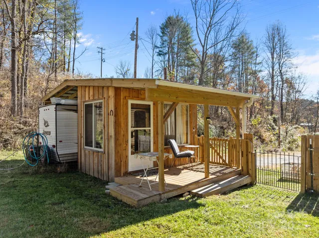 a view of a chair and table in backyard of the house