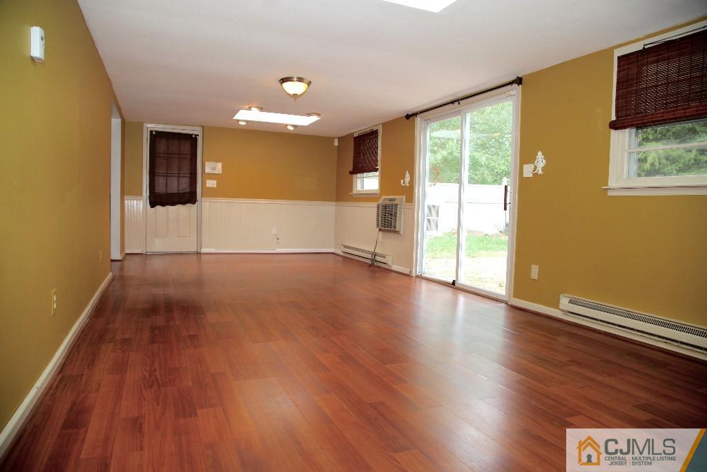47 Caldwell Road Edison, NJ 08817 - Photo 2 of 14 a view of an empty room with wooden floor and a window