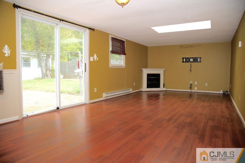 47 Caldwell Road Edison, NJ 08817 - Photo 3 of 14 a view of empty room with wooden floor and fan