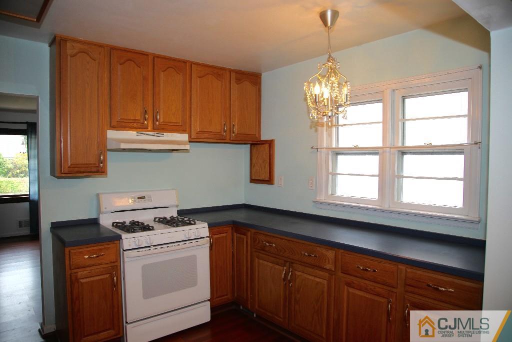 47 Caldwell Road Edison, NJ 08817 - Photo 5 of 14 a kitchen with stainless steel appliances granite countertop a sink a stove and a microwave