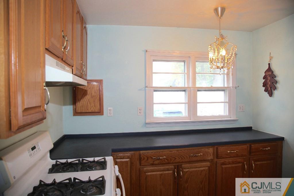 47 Caldwell Road Edison, NJ 08817 - Photo 6 of 14 a kitchen with a window wooden floor and a window