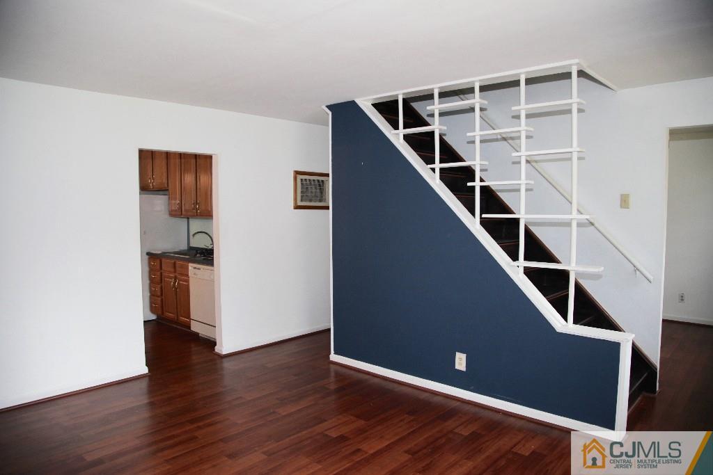 47 Caldwell Road Edison, NJ 08817 - Photo 8 of 14 a view of an empty room with wooden floor and stairs